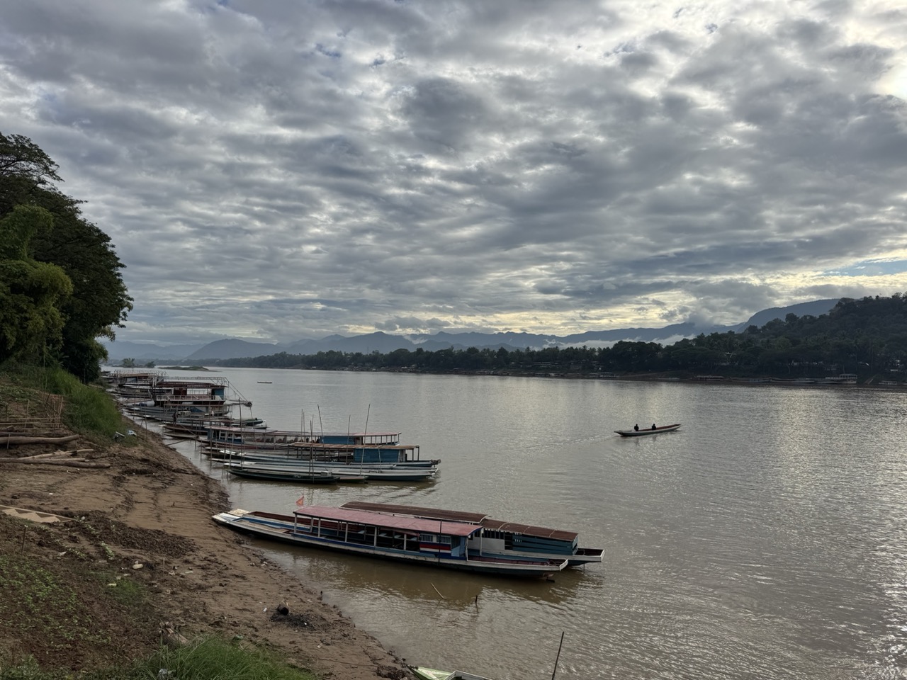 Morning boats lined up on the Mekong at the foot of Luang Prabang's old town