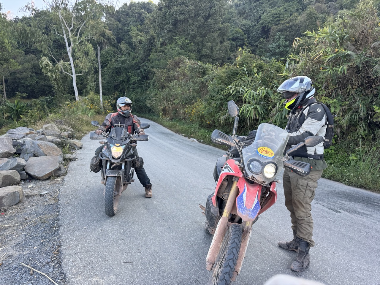 Motorcycle riders at a Phongsaly mountain viewpoint